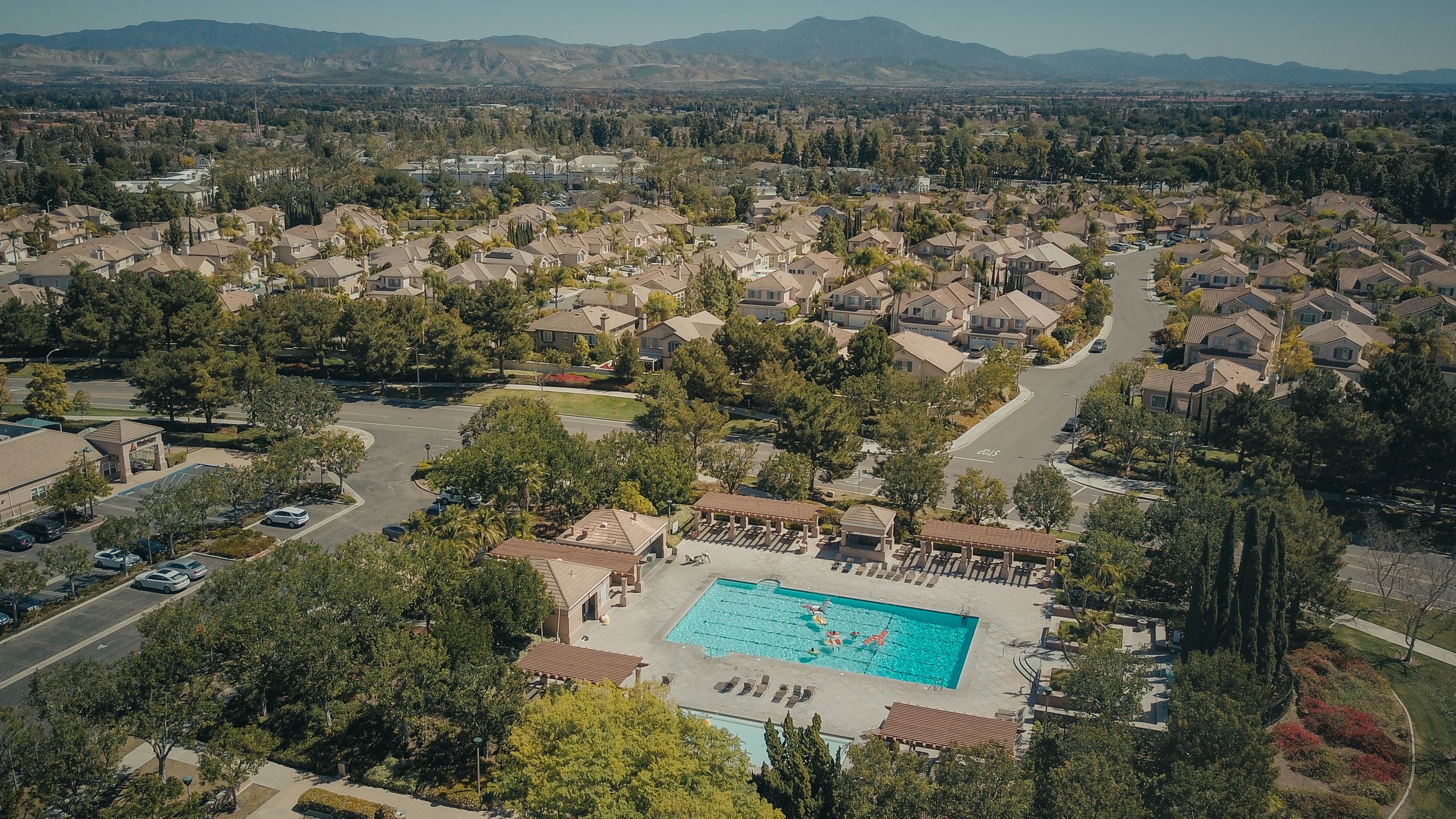 Aerial view of an active senior community with mountains beyond